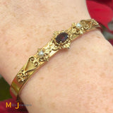 14K Yellow Gold Garnet and Seed Pearl Hinged Bangle Bracelet