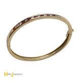 14k yellow gold ruby and diamond bangle bracelet